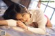 A woman laying on a bed in a white sweater.