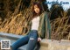 a woman sitting on top of a concrete wall