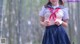 A woman in a sailor outfit is posing for a picture.