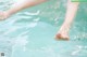 A woman's feet in a pool of water.