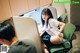 A woman sitting at a desk in front of a computer.